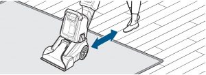Pushing the carpet cleaner backwards and forwards